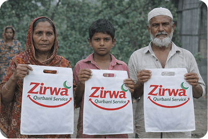 Family holding Zirwa Qurbani bags